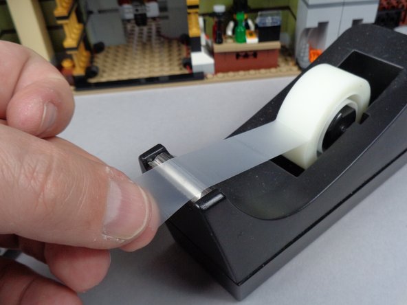 To make it easier to hold the LED Lights in place, we recommend using a piece of transparent tape as shown in the second photo.  (this tape is not included with your kit, and is optional)