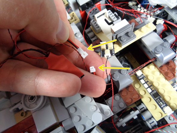 As shown by the red rectangle in the first photo for this step, locate the old laser effect controller-- it will have red shrink covering.