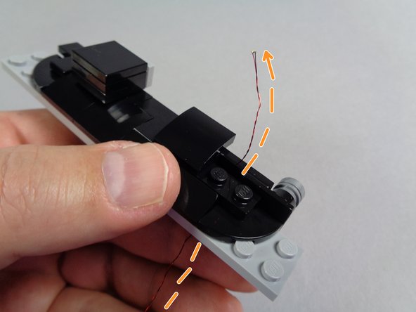 As shown in the second photo for this step, remove the right-side curved slope from above the speedometer.