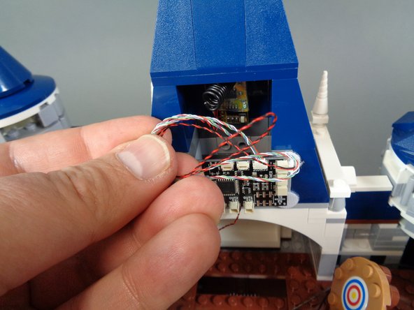 As shown by the green arrow in the second photo, connect the larger 2-wire connector from the remote control receiver to one of the three POWER plugs on the BRANCH08 master controller.