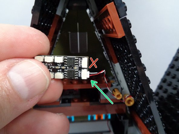As shown by the green arrow in the photo for this step, connect the other end of the 3-wire cable to the plug labeled INPUT on the third BRANCH06X adapter board.