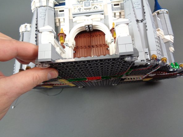 As shown in the first photo for this step, carefully tilt your castle forward, making sure no wires, plugs, or adapter boards stick out far enough to scrape on the surface you place the castle on.