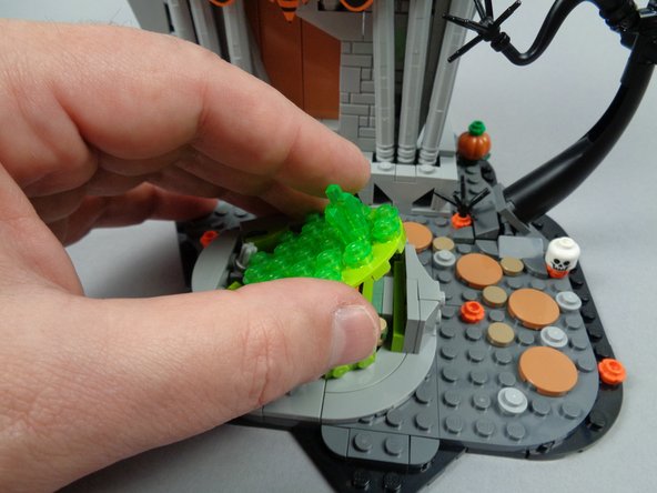 As shown in the third photo for this step, remove the large round fountain base plate.