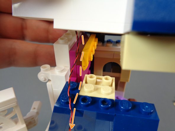 Next, carefully re-attach the roof section and top of the bedroom window frame with the light mounted.