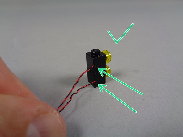 Black brick with the wire coming out the left rear (red arrow in the first photo).