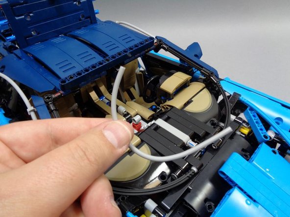 As shown in the second photo, carefully remove the light bluish gray hose inside the car.