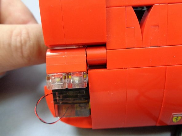 Carefully re-insert the headlight assembly back onto the main body of the car, pressing all the way in and making sure the LED wires remain on the outside of the pin and don't get pinched inside the grooves.