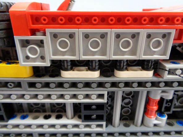 Carefully re-attach the side panels and parts you removed in the previous step, being careful not to catch the black extension cable and pinch it.