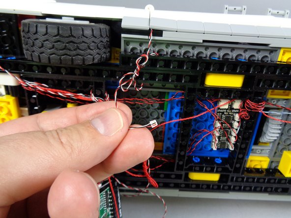 You should loop the wire several times in and out of the frame, to take up extra slack in the wire.