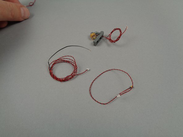 As shown in the first and second photos for this step, open the small pink bag with the orange dot and take out the warm white LED lights.