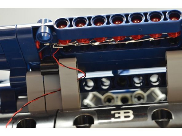 Be careful to loop the wires only through the innermost Technic beam and not through the outer beams.  This is so the spoiler will still be able to open and close smoothly without pinching any wires.