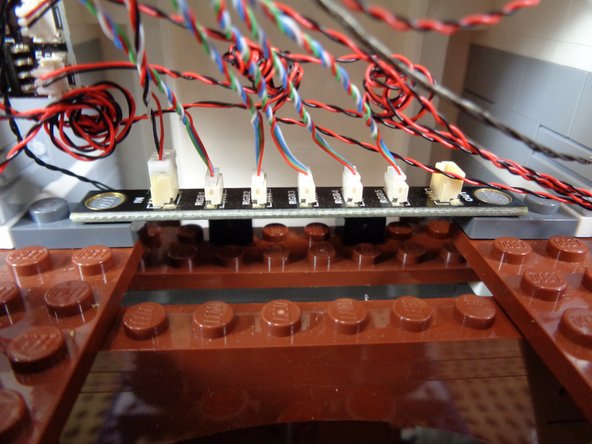 As shown in the third photo, you can use two 1x2 dark bluish gray plates (from the &quot;Lower Level Lights and Parts&quot; bag) to secure the BRANCH17 adapter board to the castle floor, just behind the warm white light strip.