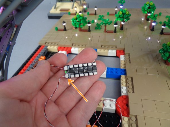 As shown by the orange arrow in the second photo for this step, connect one end of the control cable to the OUTPUT plug on the BRANCH12X driver board.