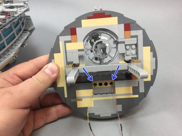 Do not pass the wires through the two inner holes, as these are used by the two black Technic pins to hold the laser cannon in place.