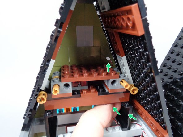 As shown by the green arrows in the second photo for this step, pass the 3-wire cable up and behind the support parts behind the painting.