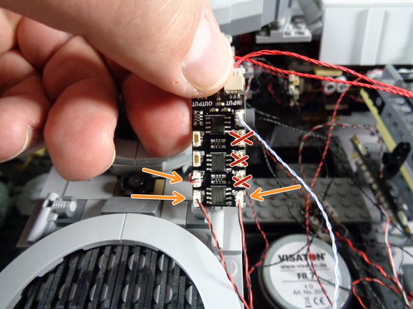 As shown in the photo, carefully connect the three doorway lights to plugs 5, 6, and 7 on the BRANCH09X adapter (the same one you connected the docking bay lights to earlier).