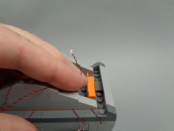 As shown in the first photo for this step, take the light wire for the front banner light.