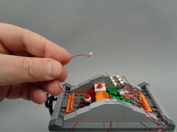 As shown in the first photo for this step, take the light wire for the spotlight.