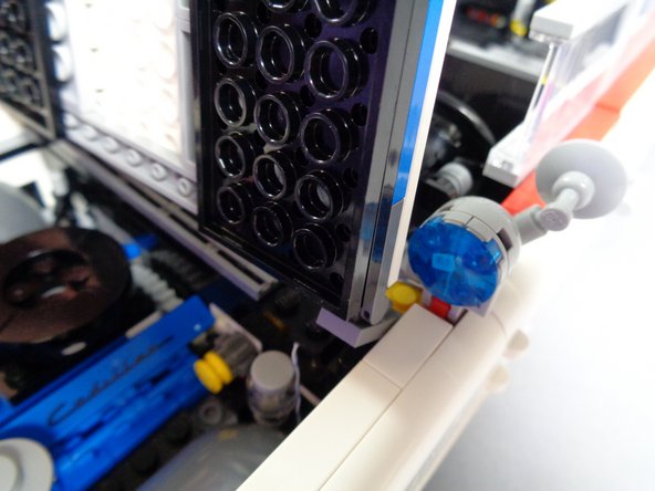 As shown in the first photo for this step, carefully re-attach the hood.