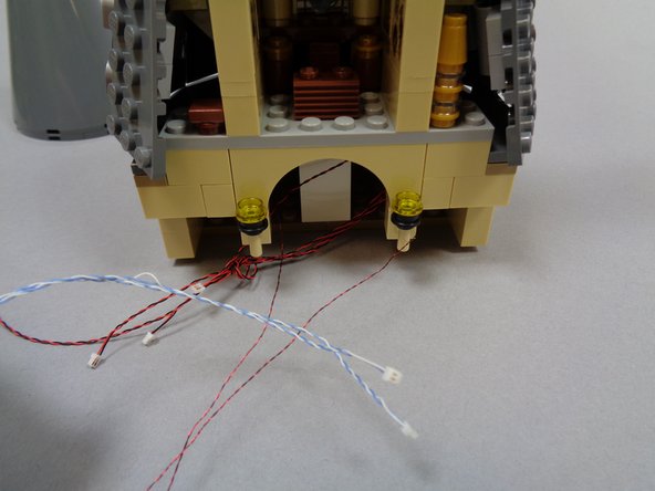 Remove the existing wall torches and tan wall bricks from below the front of Dumbledore's office.