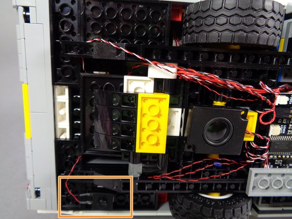 If you would like to do this, attach a large sticky square to the back side of the pushbutton as shown in the first photo.