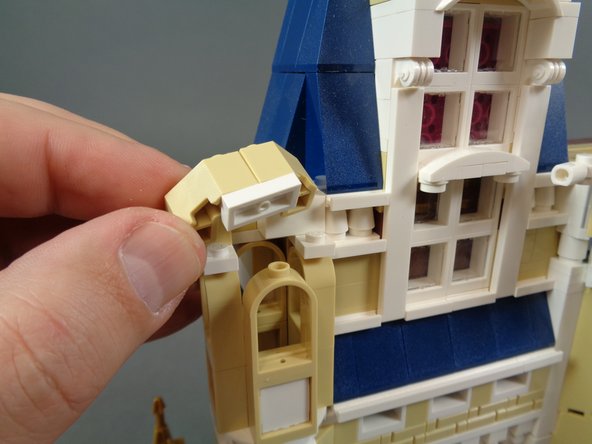 As shown in the third photo, you will need to do more disassembly of the turret to allow the LED light wire to pass down into the body of the castle.