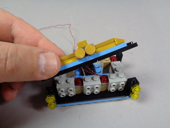 Begin re-assembling the marquee base buy replacing the top front plate as shown in the first photo for this step.