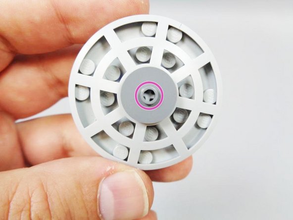 As shown by the pink circle in the second photo, the axle should be inserted all the way to the top, so it touches the upper tile.