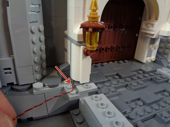 It is important to make sure that the light wire runs down the center of the back of the pillar.  This will allow the pillar to re-attach to the studs behind it without pinching the wire.