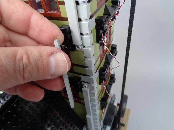 As shown in the photos for this step, remove the long supporting tiles in the middle of the tower on three sides.