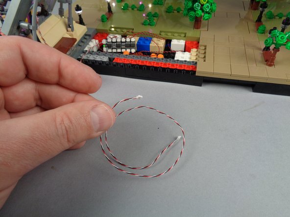 As shown in the first photo for this step, take one of the shorter 3-wire control cables from your kit bag.