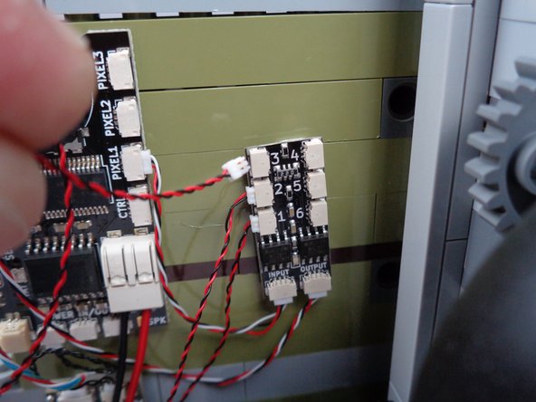 As shown in the first and second photos for this step, connect the first green LED light to plug #3 of the BRANCH06X adapter board.
