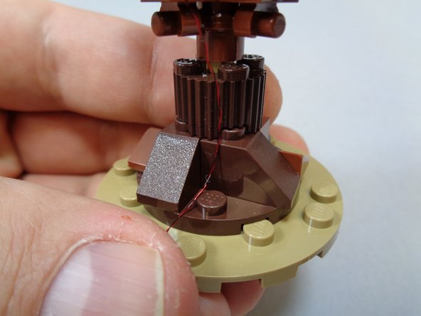 As shown in the second and third photos, remove the brown 1x1 slope from the base of the Willow and use it to hold the power wire in place.