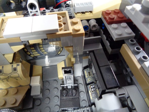 As shown in the second and third photos, carefully re-attach the computer, and replace the top frame pieces to hold it in place.