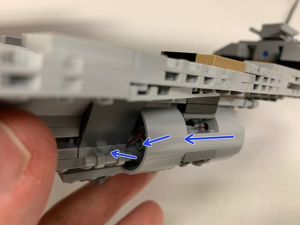 The blue arrows in the second photo show how the wires should run for the larger engines.