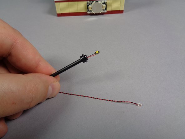 Remove the replacement lamp post section from the bag labeled &quot;Orange Lights.&quot;