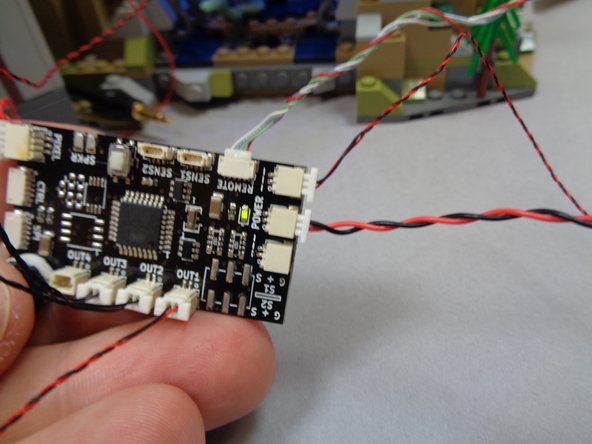 As shown in the first photo, you should have a long 3-wire connecting cable coming out of the bottom of the tower base (from when you installed lights in the tower).