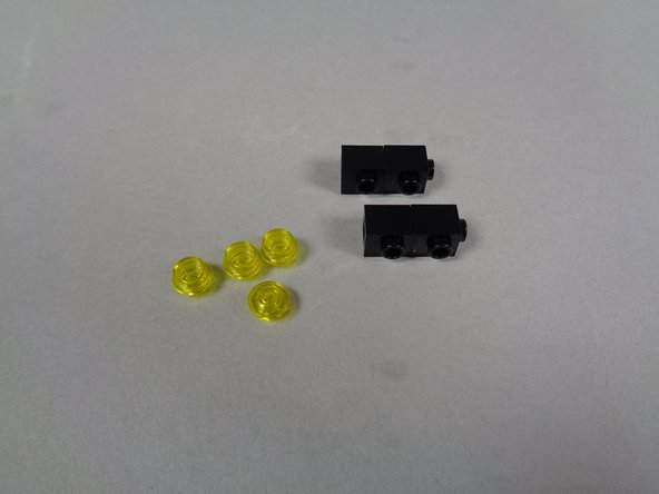 You can set the four black bricks aside-- you will not need them again.