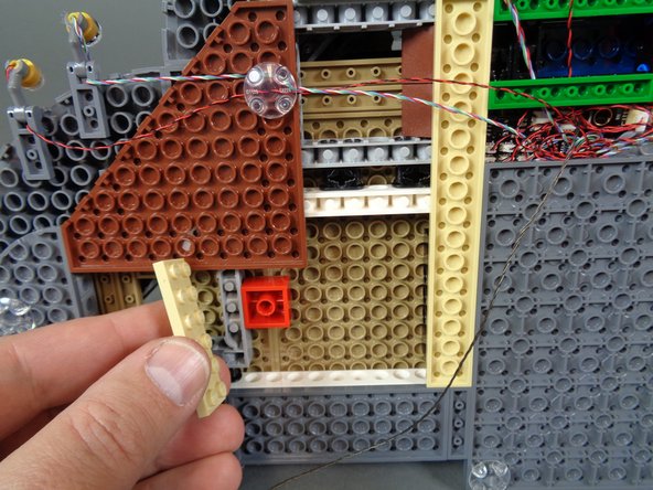 As shown in the second photo, you can remove pieces of the castle base to help hold the wire in place.  Just make sure you run the wire between, and not on top of, any studs.
