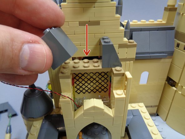 After removing the parts shown in the three photos, you should expose a gap as shown by the red arrow in the third photo.  This is where you will run the light wires in the next step.