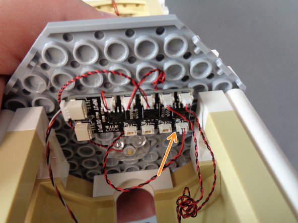 As shown by the orange arrow in the third photo, connect the warm white LED light wire from the mirror room to plug #6 on the BRANCH09X adapter board.
