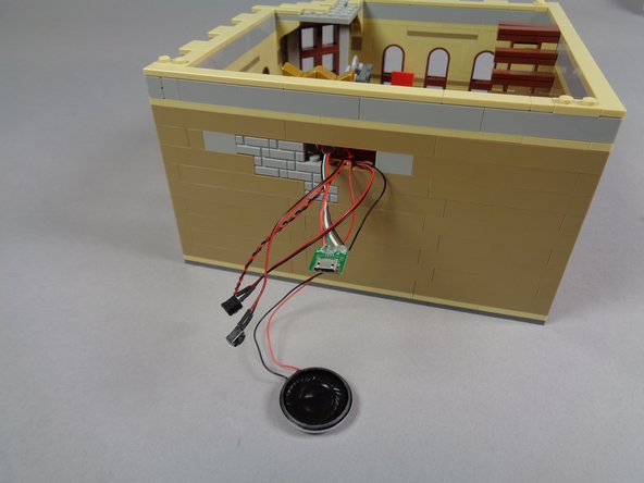 Your setup should now look like the first photo in this step, with all video player wires passing through the hole in the cinema wall.