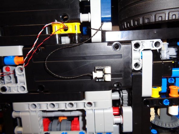 As shown in the first photo (green circle), connect one end of the 12&quot; black connecting cable to the last open connector on the main control board.
