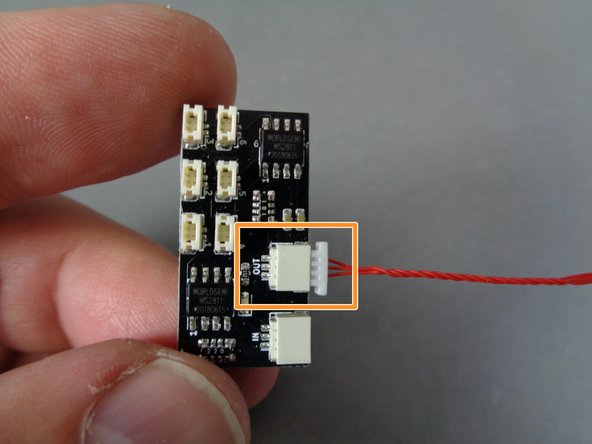 As shown by the orange rectangle in the second photo, connect one end of the red wire to the large plug on the BRANCH09XS adapter board labeled &quot;OUT&quot;.