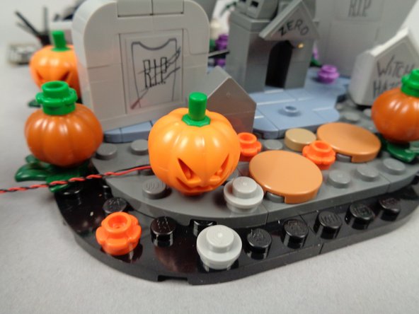 Make sure the LED light wire is coming out the back side of the pumpkin as shown.