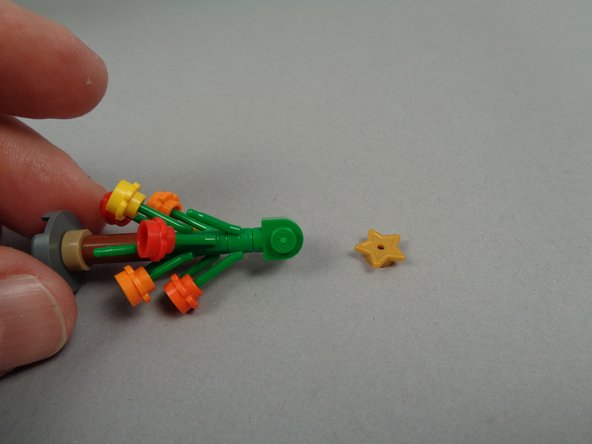 As shown in the second photo, remove the gold star from the top of the tree.