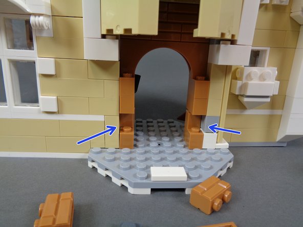 As shown by the blue arrows in the second photo, make sure to remove the two light brown bricks from the oven wall.