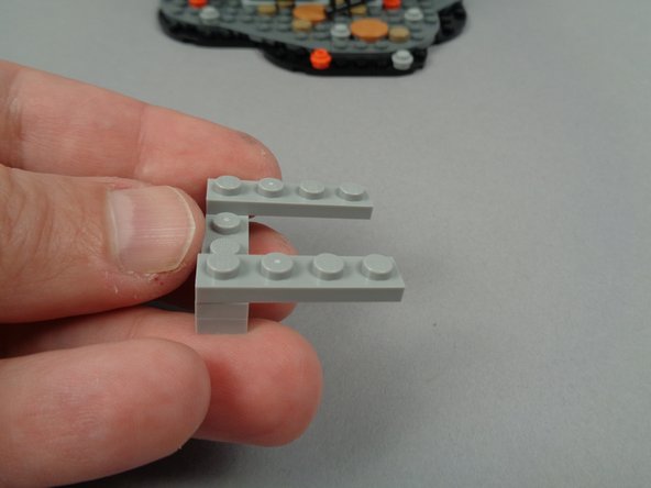 The photos for this step show how to use the five Light Bluish Gray parts from your &quot;Brick Parts&quot; bag to construct a support base for the wires.