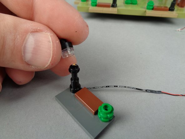 As shown in the first photo for this step, you can re-attach the top pieces of the lamp post.