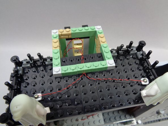 Make sure the light wires run BETWEEN the studs on the roof top, not on top of any studs.  Wires can become pinched or damaged if you place LEGO® parts on top of them if they run on top of studs.